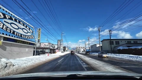 Car moves from traffic light onto wet winter road in Hakodate city Video stock 333069433