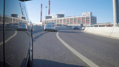 The car is moving along the highway junction on a sunny summer day. Side view of Stock Footage 101237433