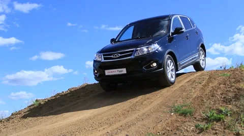 Car moving down from the hill with clouds at the background Stock Footage 47834564