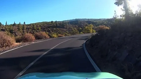 Car moving down a road in mountains Stock Footage 72183836