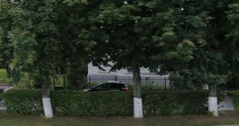 The car is moving down the street side view aerial Stock Footage 127482815