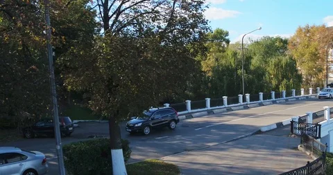 The car is moving down the street side view aerial Stock Footage 127482859