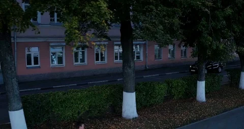 The car is moving down the street side view aerial Stock Footage 127483790