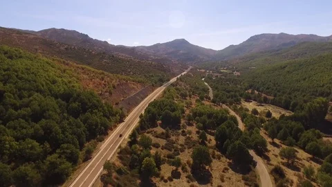  Car Moving On Mountain Road Against Blue Clear Sky Stock Footage 82397628