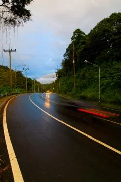 The car is moving quickly on the road. Stock Photos