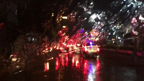 Car moving in rain at night through a city Stock Footage 104840669