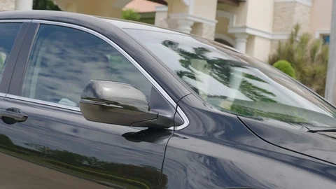 Car moving with reflections of sky and green trees reflected on glass &amp; car body Stock Footage 93585065