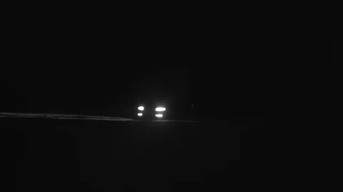 Car moving on the road in darkness with headlights on. Stock Footage 104885503