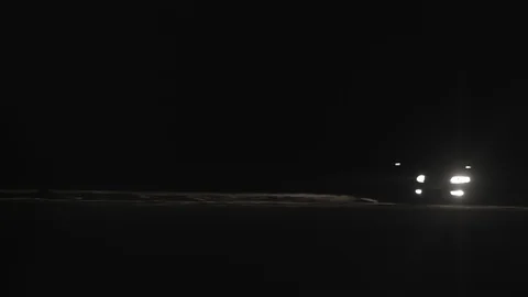 Car moving on the road in darkness with headlights on. 스톡 동영상 104885508