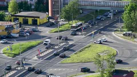 Car moving on road intersection during day time Видео 143461361