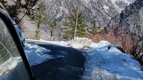 Car moving on Sharp turns In The Middle Of The Snow on Mountains Stock Footage 159633341