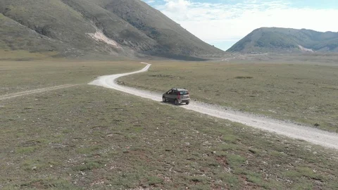 Car in the nature white mountain path in natural reserve blue sky Stock Footage 95220715