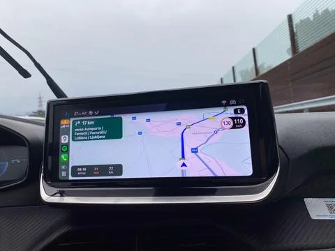 Car navigation system displaying route and speed limit on a modern dashboard Stock Photos
