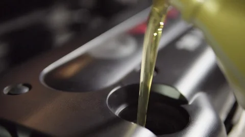 Car oil is poured into the engine. 4k Stock Footage 74485002