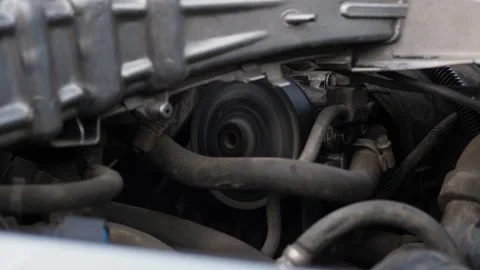 A car with an open hood and a working timing belt at a service station. Stock Footage 336666685