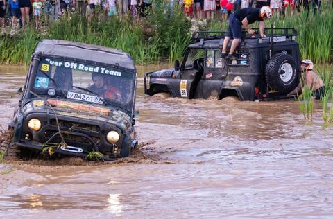 The car overcomes difficult obstacles. Large-scale sports competitions Stock Photos