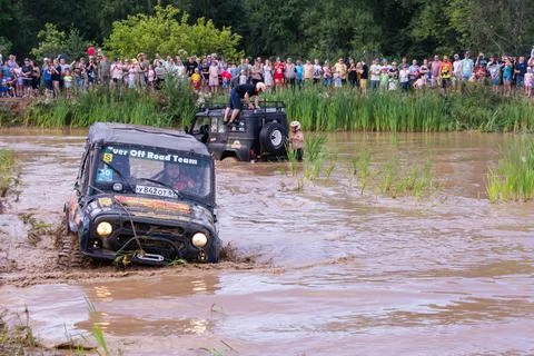 The car overcomes difficult obstacles. Large-scale sports competitions Stock Photos