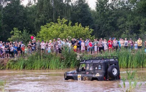 The car overcomes difficult obstacles. Large-scale sports competitions Stock Photos