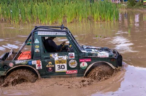 The car overcomes difficult obstacles. Large-scale sports competitions Stock Photos