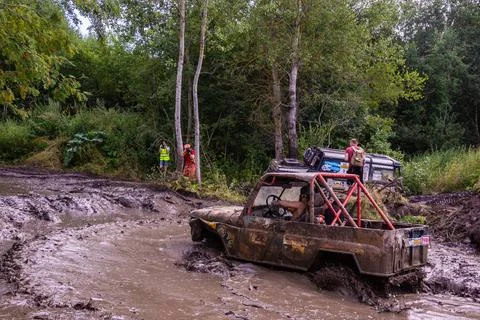 The car overcomes difficult obstacles. Large-scale sports competitions Stock Photos