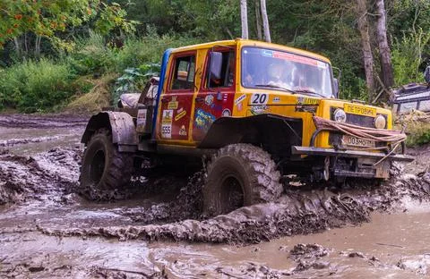 The car overcomes difficult obstacles. Large-scale sports competitions Stock Photos