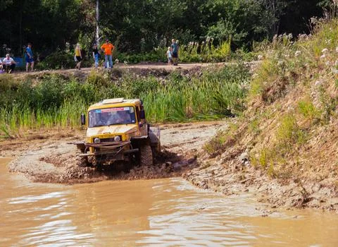 The car overcomes difficult obstacles. Large-scale sports competitions Stock Photos