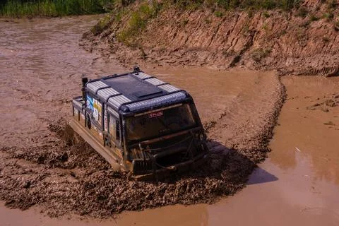 The car overcomes difficult obstacles. Large-scale sports competitions Stock Photos