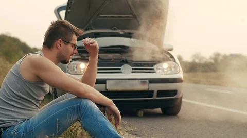 Car with overheated engine and sad man Stock Footage 79216047