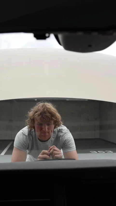 Car owner uses a screwdriver to begin repairing the vehicle himself Stock Footage 342919327