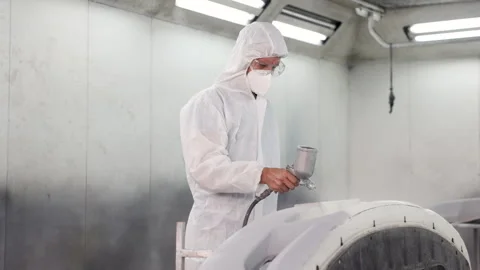 Car painter with mask using spray gun painting car spare parts in painting .. Stock Footage 242827129