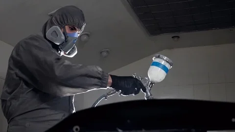 Car painter paint auto at body workshop low angle slow motion Stock Footage 102300725