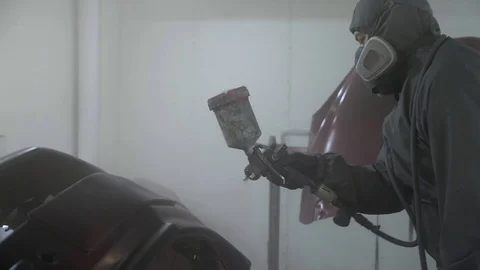 Car painter paint bumper at auto body service, slow motion. Stock Footage 86561316