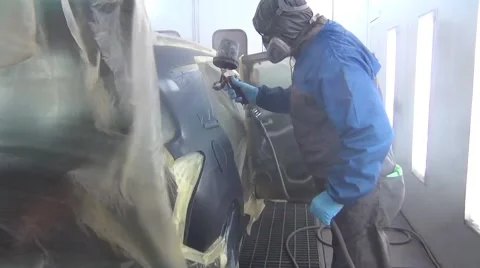 Car painter is painting the body work of a car in a paint box Stock Footage 61166435