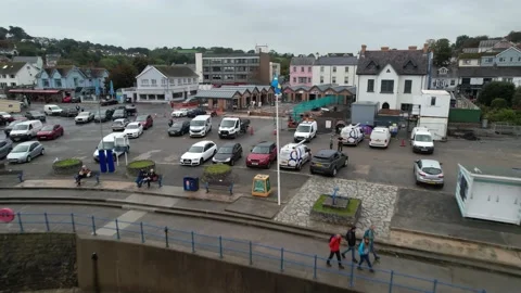 Car park, flag on pole and walkway at waterfront Stock Footage 166647579