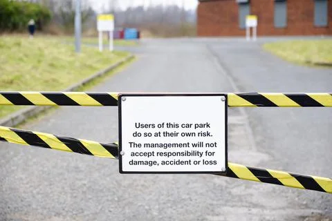 Car park users do so at own risk sign Stock Photos