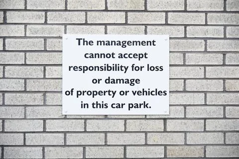 Car park users do so at own risk sign Stock Photos