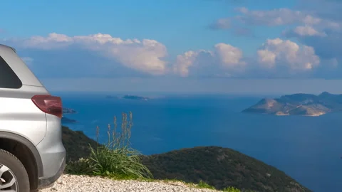 The car is parked against the backdrop of an endless seascape Stock Footage 327970203