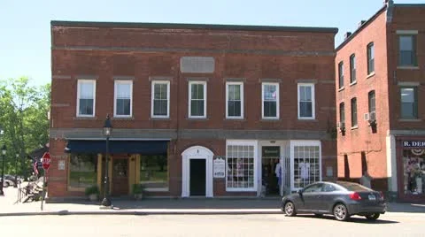 Car parked in front of small brick building Stock Footage 8981512