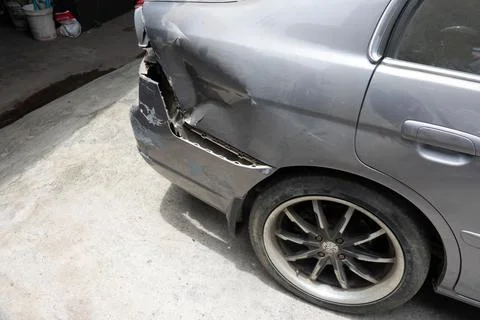 A car is parked with its back end smashed Stock Photos