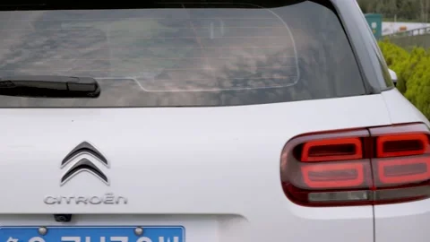 Car parked on the side of the road behind the grass Stock Footage 157623789