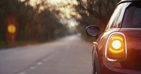 A car parked on the side of the road during sunrise, before a new journey. Stock Footage