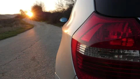 Car Parked on the Side of the Road Opposite the Sunset Stock Footage 172304833