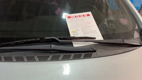 A car with a parking ticket Stock Footage 232558295