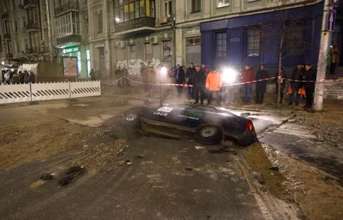 Car partially collapsed under the ground Stock Photos