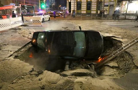 Car partially collapsed under the ground Stock Photos
