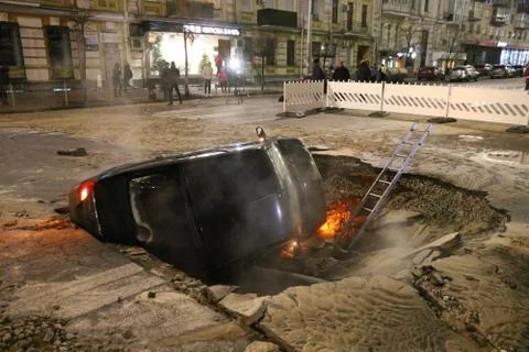 Car partially collapsed under the ground Stock Photos