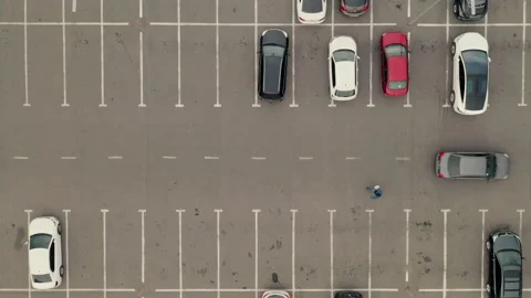 Car pass throw the parking lot. Car leaves the parking lot - aerial top overhead Stock Footage 170271545