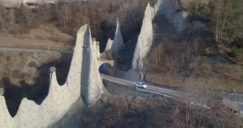 Car pass under Euseigne Pyramides - Aerial 4K Stock Footage 106230057