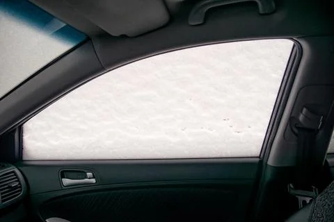 Car passenger side window in snow - view from the passenger compartment Stock Photos