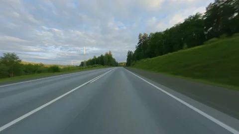 The car passes between two hills covered with dense vegetation. countryside Stock Footage 158303644